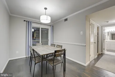 a view of a dining room with furniture wooden floor and chandelier