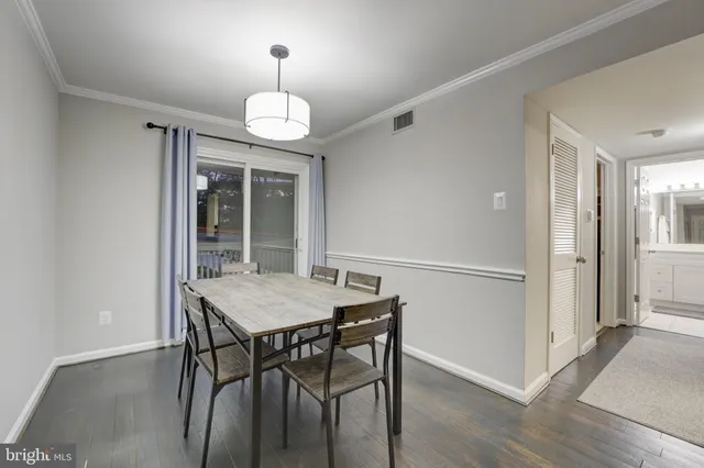 a view of a dining room with furniture wooden floor and chandelier