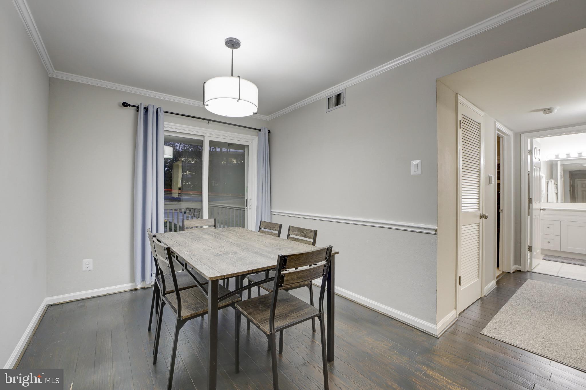 1501 Lincoln Way, Unit 101 McLean, VA 22102 - Photo 8 of 23 a view of a dining room with furniture window and wooden floor