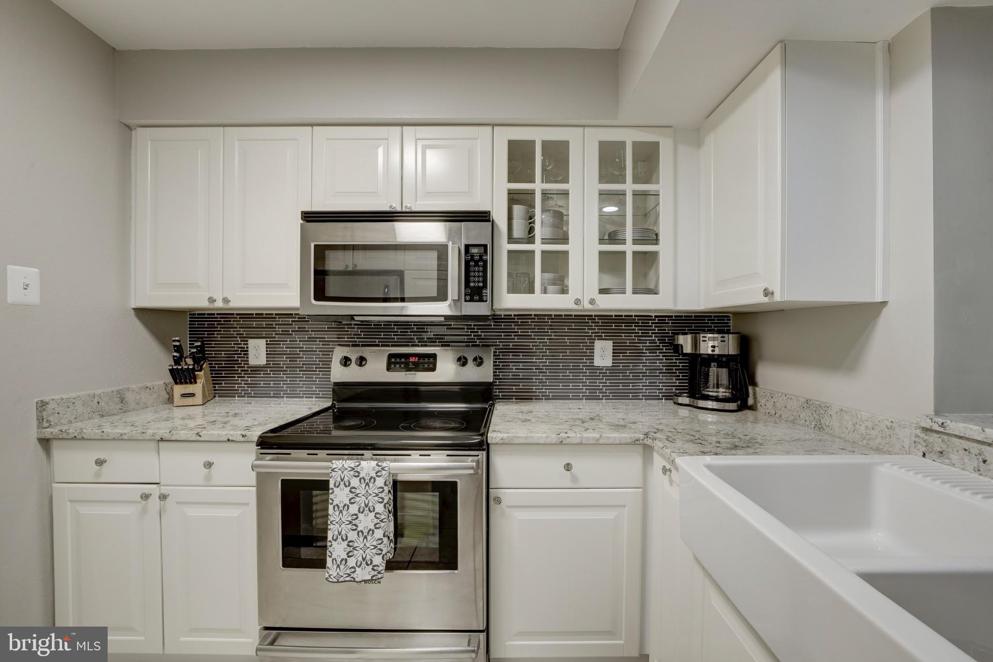 1501 Lincoln Way, Unit 101 McLean, VA 22102 - Photo 9 of 23 a kitchen with cabinets stainless steel appliances and a sink