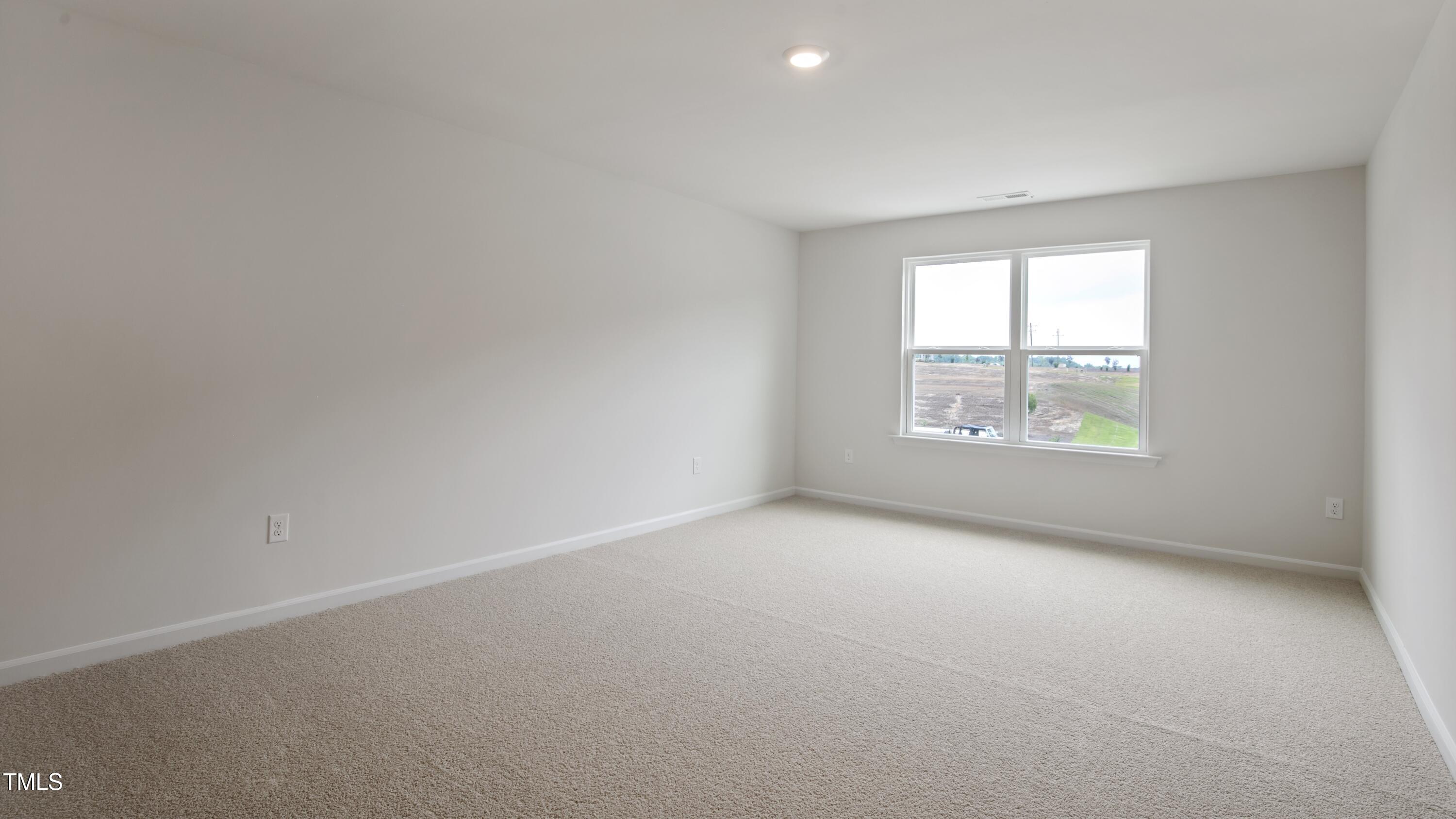 845 Comice Pear Way Willow Spring, NC 27592 - Photo 18 of 36 an empty room with windows