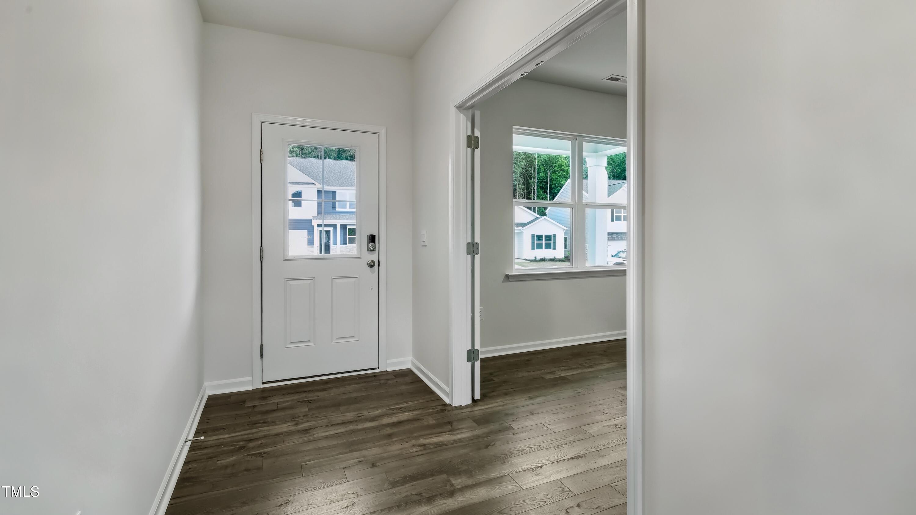 845 Comice Pear Way Willow Spring, NC 27592 - Photo 2 of 36 an empty room with wooden floor and a way to dining room