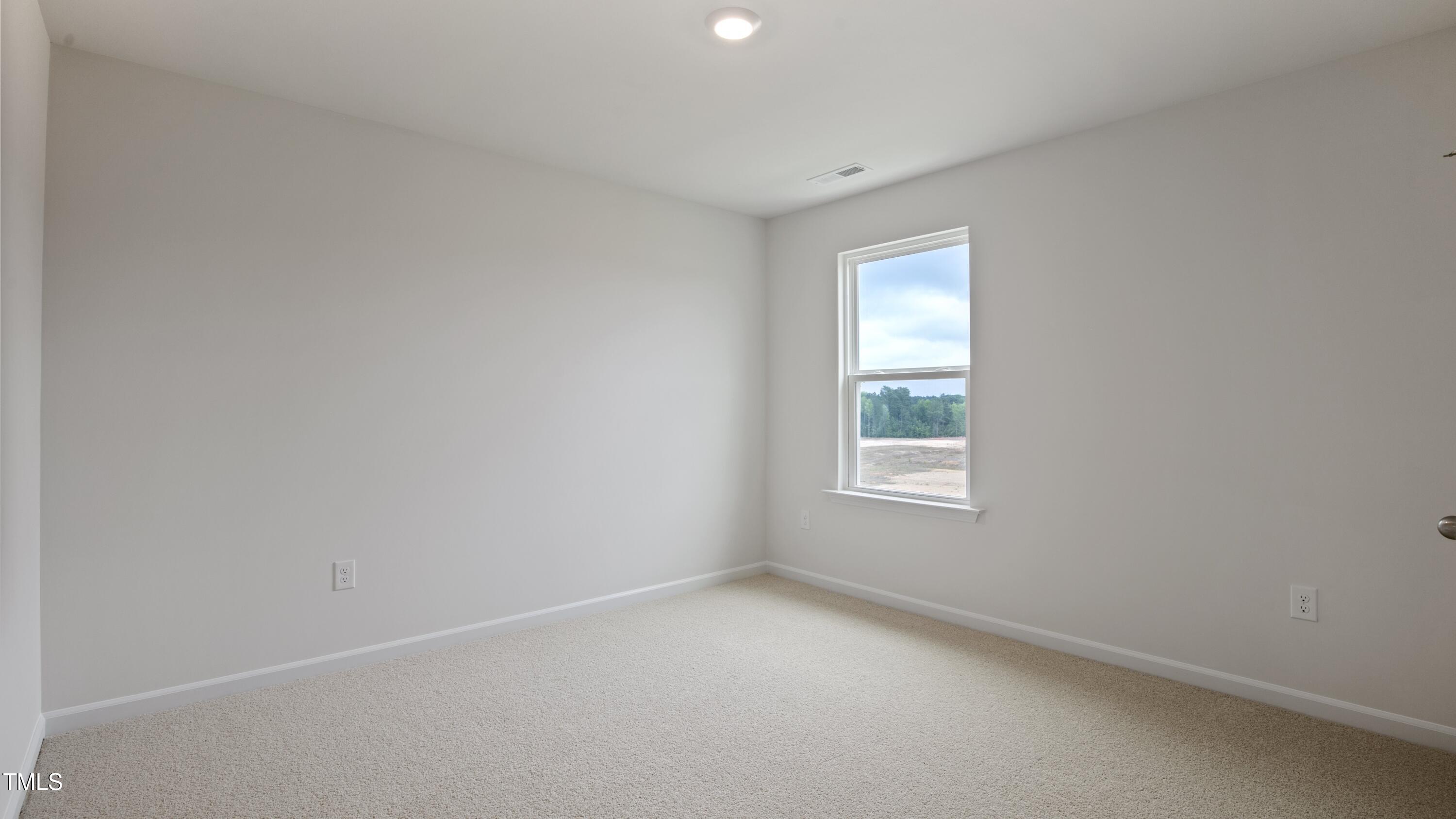 845 Comice Pear Way Willow Spring, NC 27592 - Photo 24 of 36 a view of an empty room with a window