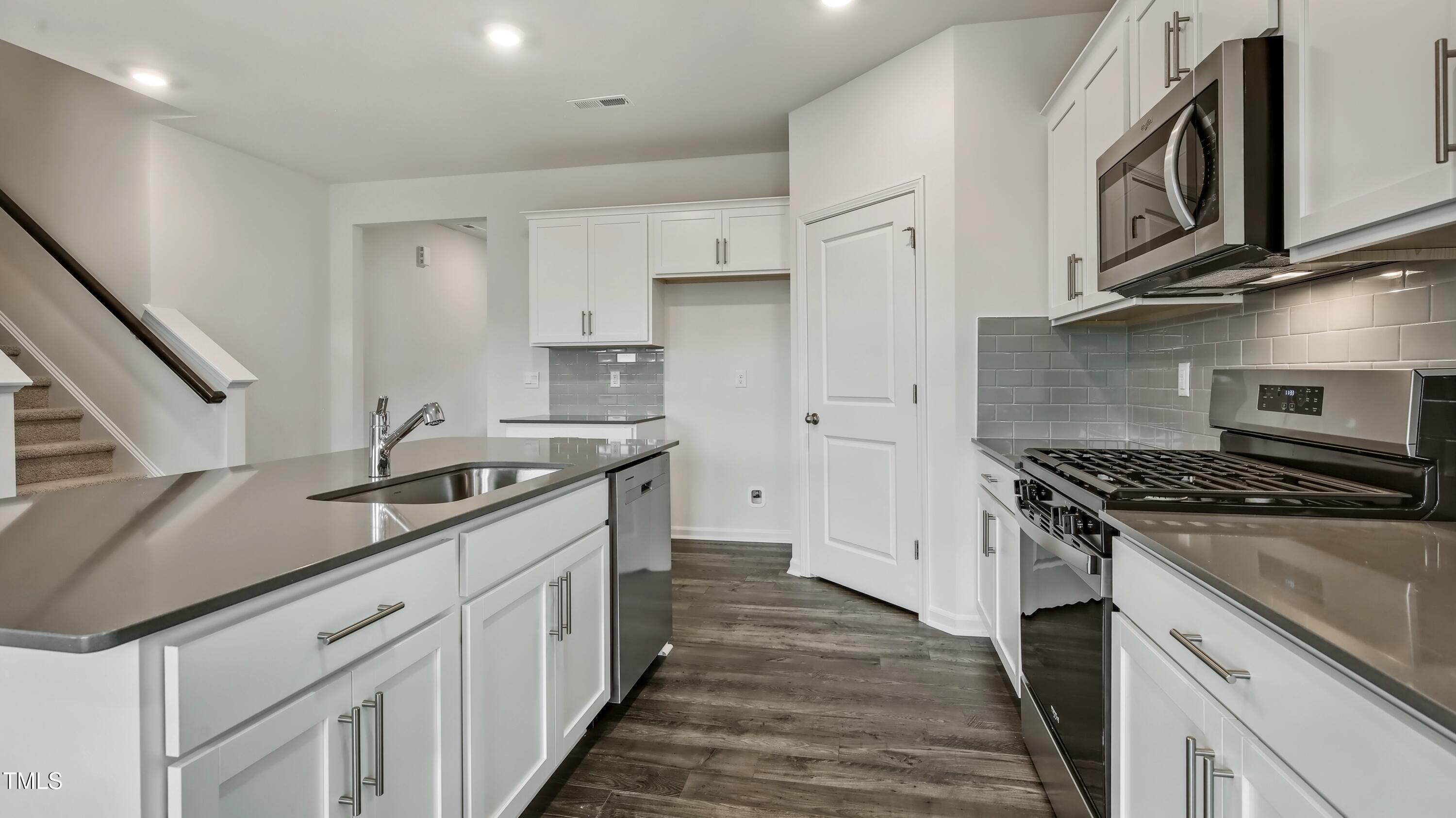 845 Comice Pear Way Willow Spring, NC 27592 - Photo 8 of 36 a kitchen with stainless steel appliances granite countertop a stove and a sink