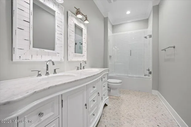 a spacious bathroom with a granite countertop sink toilet a large mirror a bathtub and shower