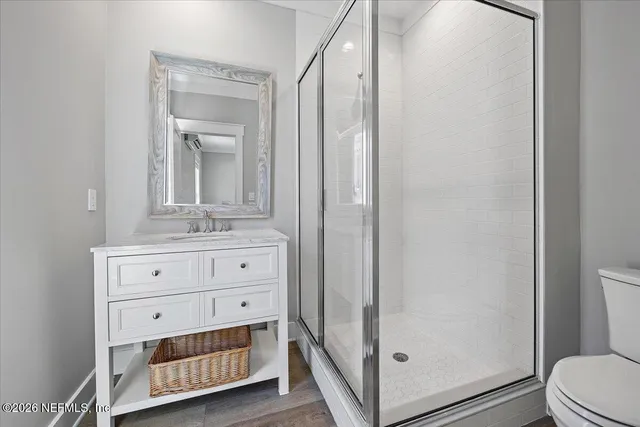 a bathroom with a double vanity sink a toilet and a mirror