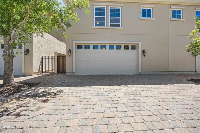 a view of a grey house with a yard
