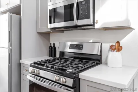 a stove top oven sitting inside of a kitchen