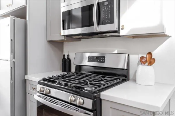 a stove top oven sitting inside of a kitchen