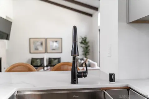 a kitchen with a sink and a mirror