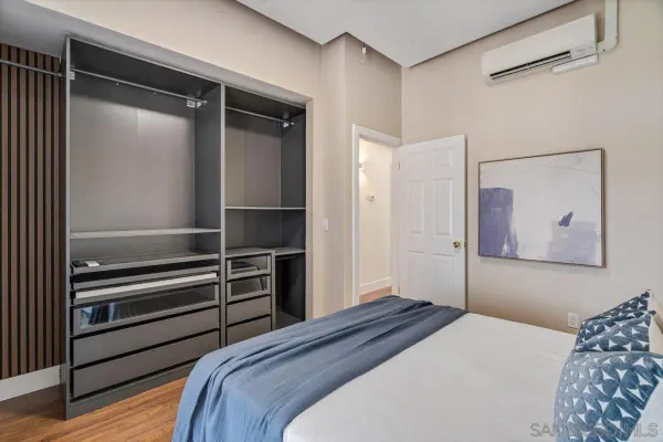 a bedroom with a bed and a walk in closet
