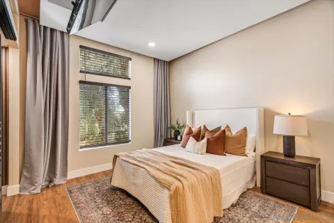 a bedroom with a large bed and a window