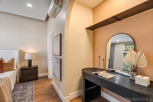 a en suite bathroom with a granite countertop sink and a mirror