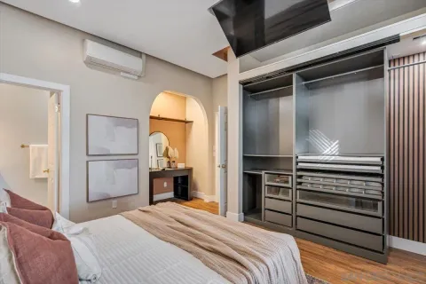 a bedroom with a bed and a dresser