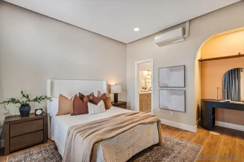 a bedroom with bed and wooden floor