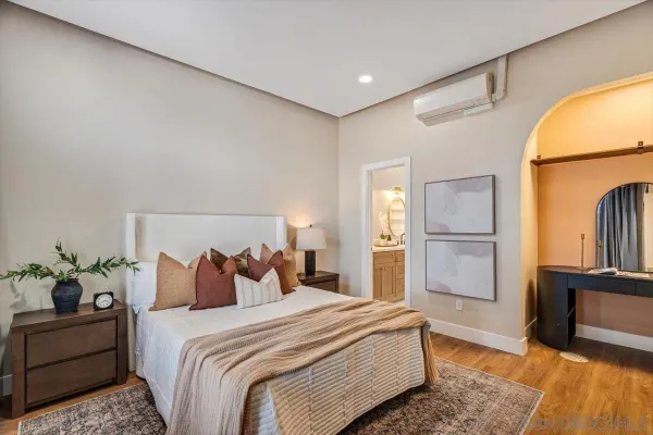 a bedroom with bed and wooden floor