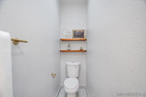 a white toilet sitting next to a bathroom sink
