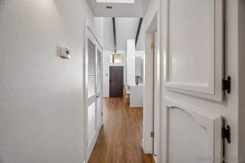 a view of a hallway with wooden floor and staircase