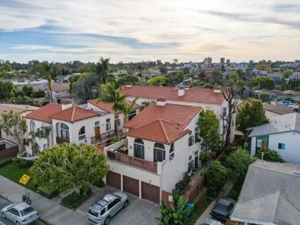 an aerial view of multiple houses with a yard