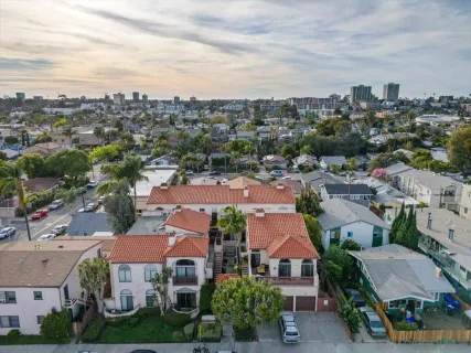 an aerial view of residential houses with city view