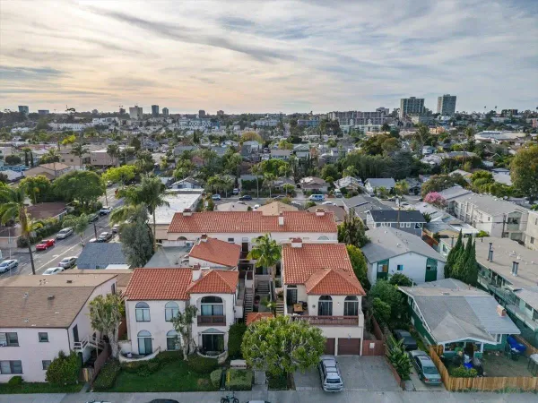 an aerial view of residential houses with city view