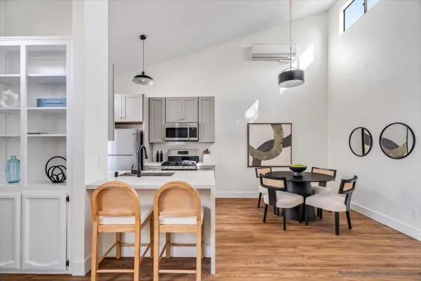a view of a dining room with furniture kitchen and wooden floor