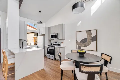 a kitchen with a dining table and chairs