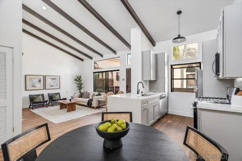 a living room with kitchen island furniture and a chandelier