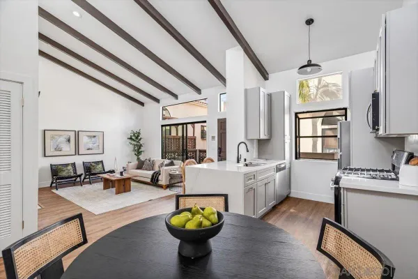 a living room with kitchen island furniture and a chandelier