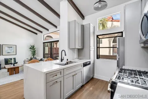 a view of a kitchen with a sink a window and stainless steel appliances