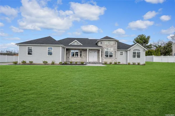 a front view of a house with a garden
