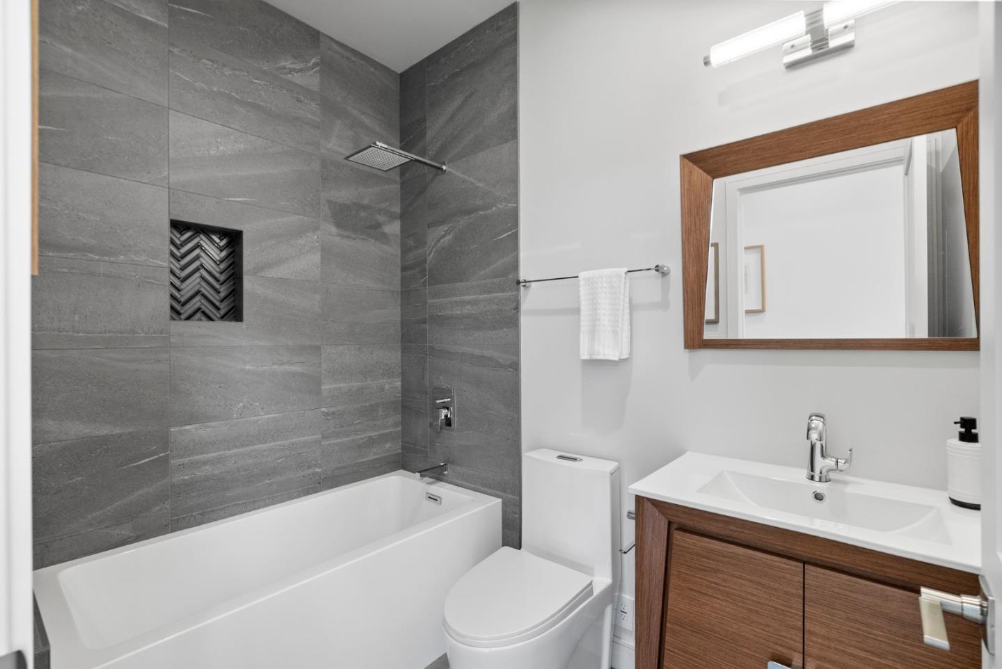 829 Sutter Avenue Sunnyvale, CA 94086 - Photo 23 of 36 a bathroom with a granite countertop sink toilet a mirror and bathtub