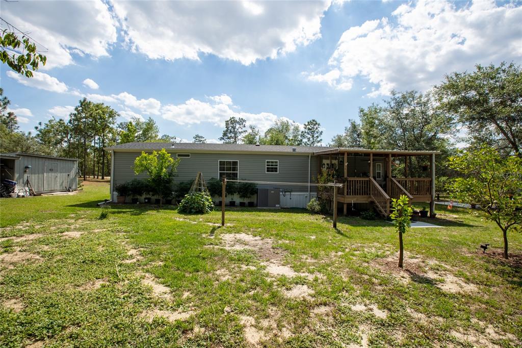 5670 Acadia Street Keystone Heights, FL 32656 - Photo 15 of 65 a view of a house with backyard and sitting area