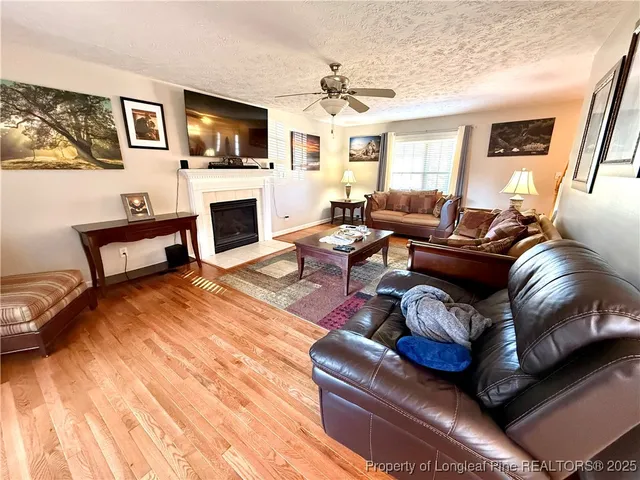 a dining room with furniture a rug and wooden floor