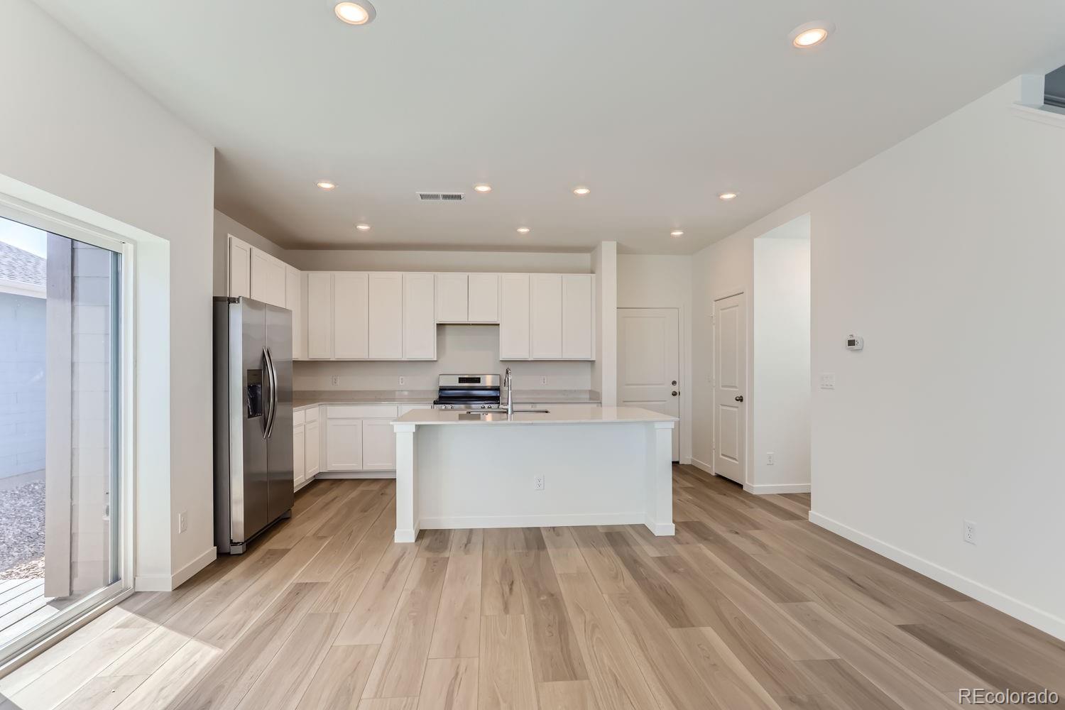 640 Aspen Avenue Bennett, CO 80102 - Photo 3 of 16 a view of kitchen with wooden floor