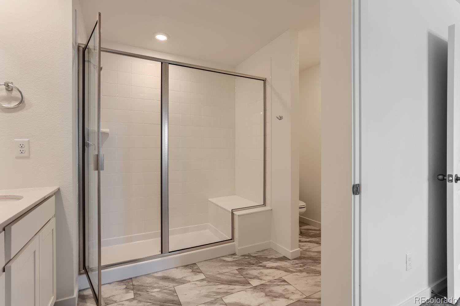 640 Aspen Avenue Bennett, CO 80102 - Photo 6 of 16 a bathroom with a shower and a toilet