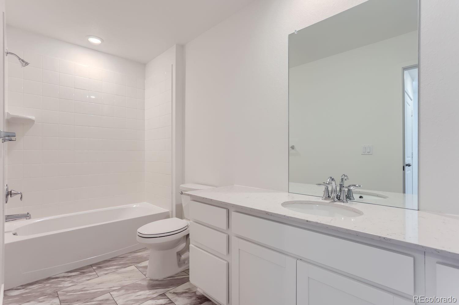 640 Aspen Avenue Bennett, CO 80102 - Photo 9 of 16 a bathroom with a sink a toilet and shower