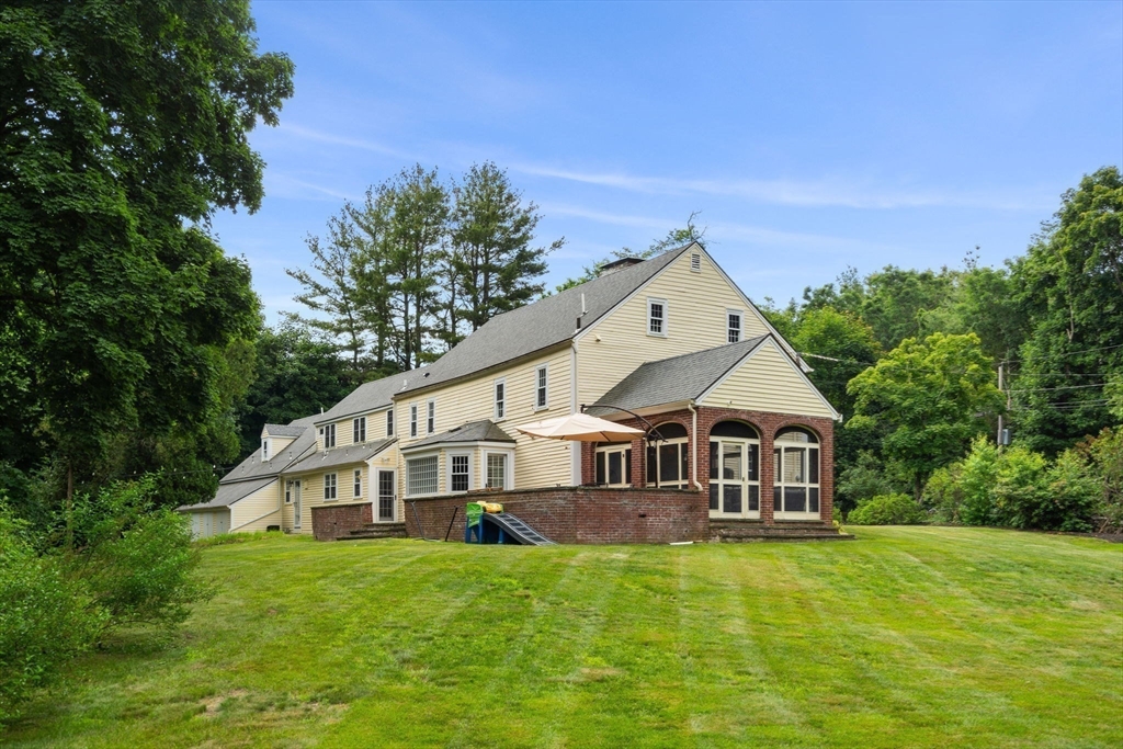 161 Spofford Road Boxford, MA 01921 - Photo 5 of 30 a front of a house with a big yard and large trees