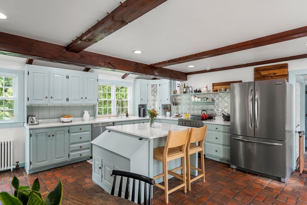161 Spofford Road Boxford, MA 01921 - Photo 7 of 30 a kitchen with stainless steel appliances a dining table chairs refrigerator and cabinets