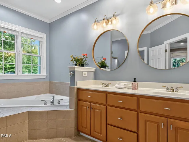 a bathroom with a tub sink and mirror