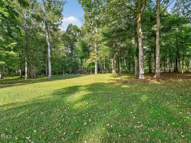 a view of a backyard with table and chairs