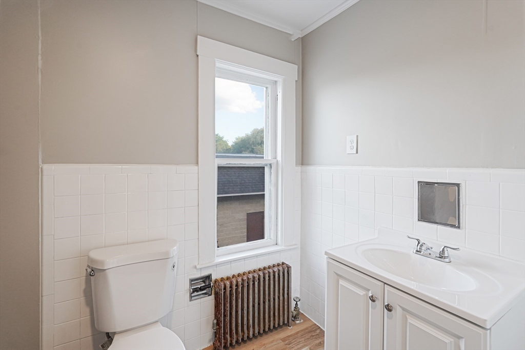 72 Main Street Pepperell, MA 01463 - Photo 17 of 26 a bathroom with a toilet sink vanity and mirror