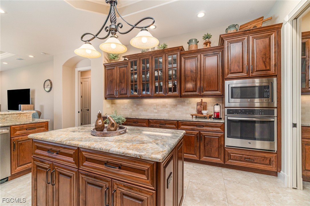 6135 Calusa Rdg Trail Bokeelia, FL 33922 - Photo 11 of 46 a kitchen with granite countertop a sink and stove
