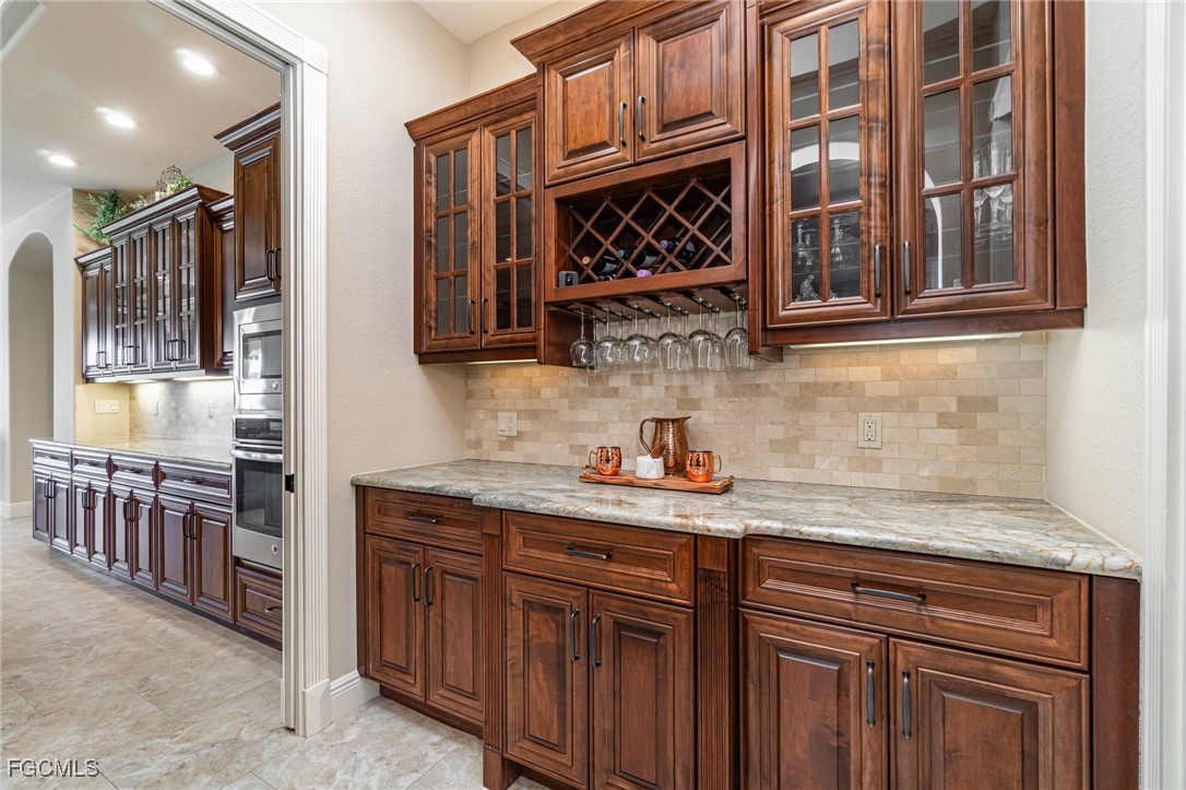 6135 Calusa Rdg Trail Bokeelia, FL 33922 - Photo 12 of 46 a kitchen with stainless steel appliances granite countertop a sink and cabinets