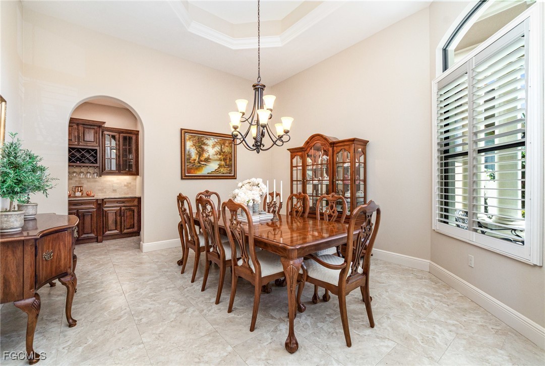 6135 Calusa Rdg Trail Bokeelia, FL 33922 - Photo 13 of 46 a dining room with furniture a chandelier and window