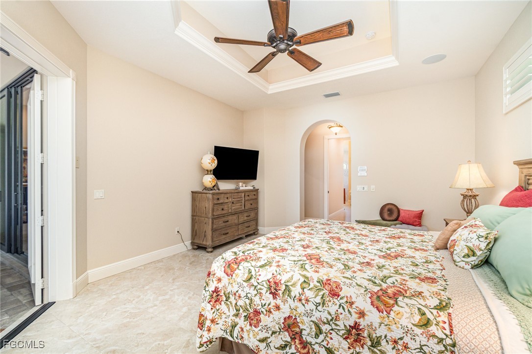6135 Calusa Rdg Trail Bokeelia, FL 33922 - Photo 21 of 46 a bedroom with a bed and a tv on table