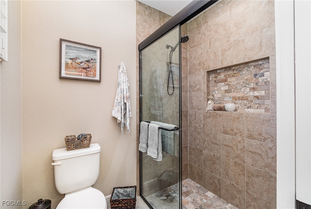 6135 Calusa Rdg Trail Bokeelia, FL 33922 - Photo 28 of 46 a bathroom with a toilet sink and shower