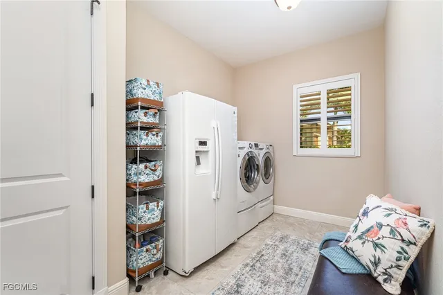 a view of a livingroom with fridge and hallway