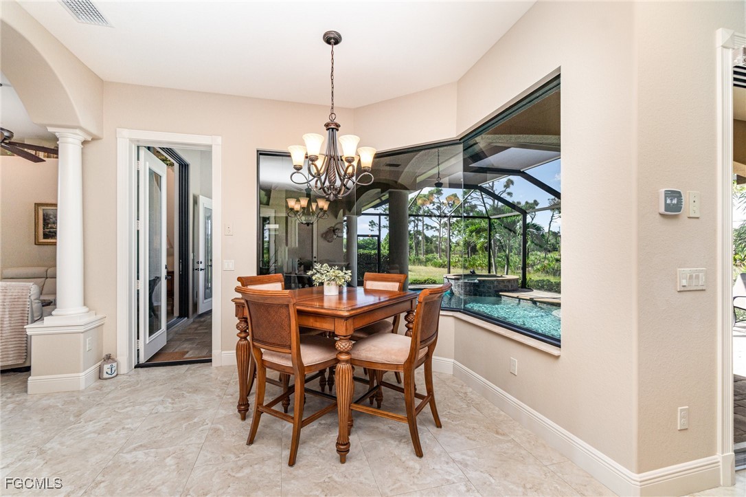 6135 Calusa Rdg Trail Bokeelia, FL 33922 - Photo 5 of 46 a view of a dining room with furniture window and outside view