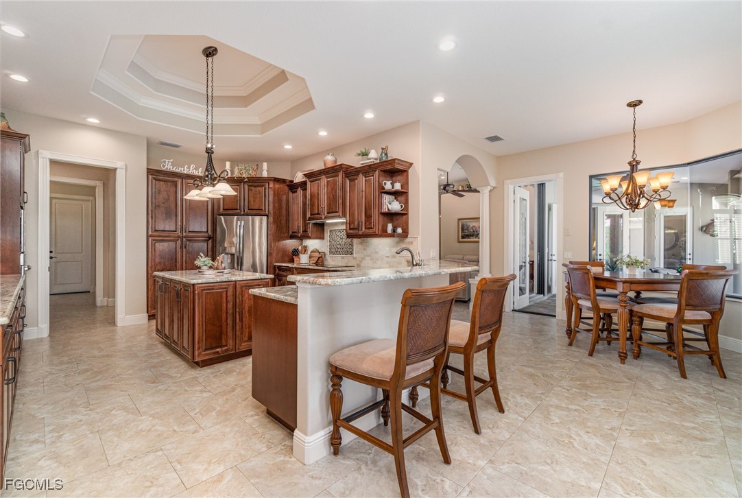6135 Calusa Rdg Trail Bokeelia, FL 33922 - Photo 6 of 46 a large kitchen with a table and chairs